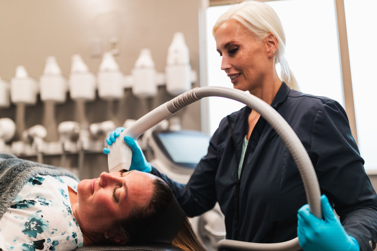 Gloved clinician applying a Sofwave ultrasound handpiece to a patient's face at Element Dermatology